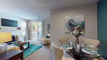 A living room with a table and chairs and a fireplace